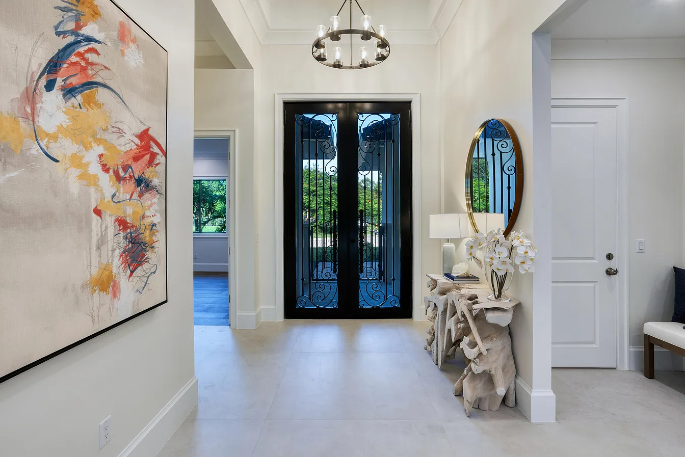 Entry hall with decorative lighting and a dark framed doorway